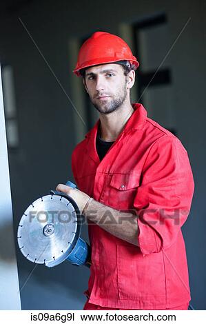 Stock Image - Portrait of building contractor with circular saw. Fotosearch