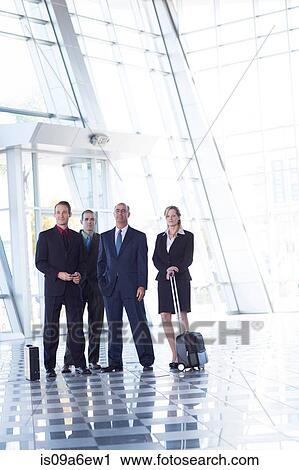 Stock Image - Portrait of businesspeople in airport. Fotosearch
