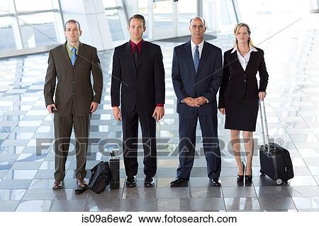 Stock Image - Portrait of businesspeople in airport. Fotosearch