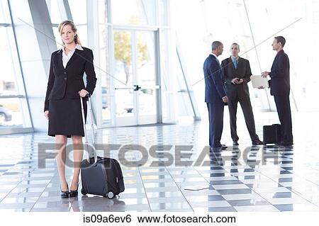 Portrait of businesswoman in airport with suitcase View Large Photo Image Stock Photograph - Portrait of businesswoman in airport with suitcase. Fotosearch