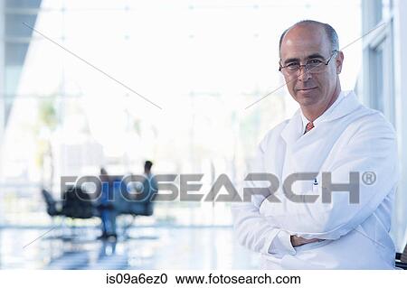 Portrait of mature male doctor wearing glasses View Large Photo Image Stock Image - Portrait of mature male doctor wearing glasses. Fotosearch