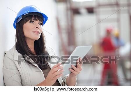 Portrait of woman with blue hard hat and digital tablet View Large Photo Image Stock Photography - Portrait of woman with blue hard hat and digital tablet. Fotosearch