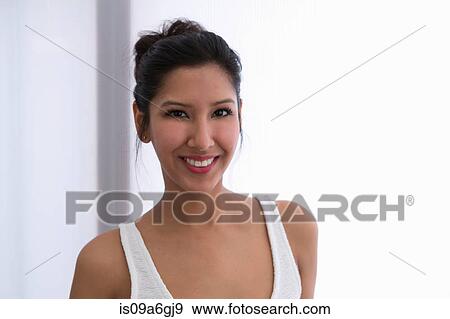 Stock Photo - Portrait of young woman wearing white vest. Fotosearch