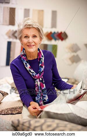 Senior woman choosing textile swatches View Large Photo Image Stock Image - Senior woman choosing textile swatches. Fotosearch