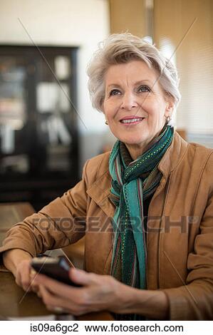 Senior woman holding cell phone View Large Photo Image Stock Image - Senior woman holding cell phone. Fotosearch
