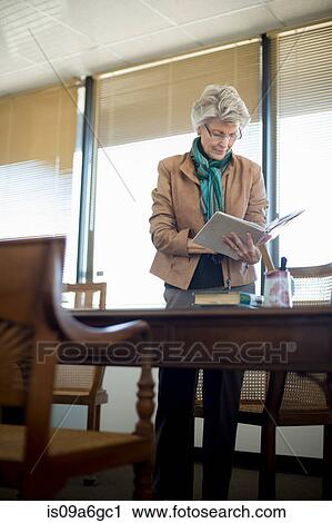 Senior woman reading notebook View Large Photo Image Stock Image - Senior woman reading notebook. Fotosearch