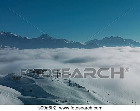 Ski lifts in ski resort with low cloud View Large Photo Image Stock Image - Ski lifts in ski resort with low cloud. Fotosearch