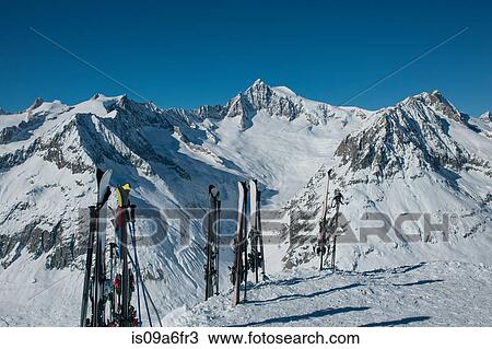 Stock Image - Skis standing in snow in mountains. Fotosearch