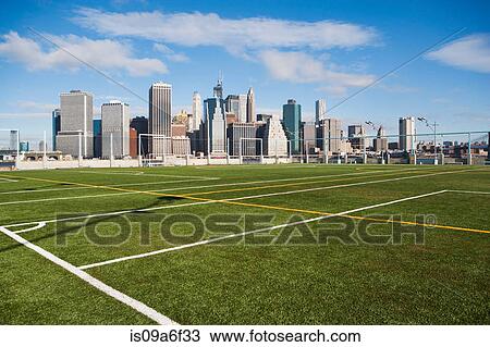 Stock Image - Soccer fields and Lower Manhattan skyline, New York City, USA. Fotosearch