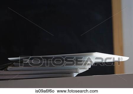 Stack of notebooks and digital tablet View Large Photo Image Picture - Stack of notebooks and digital tablet. Fotosearch