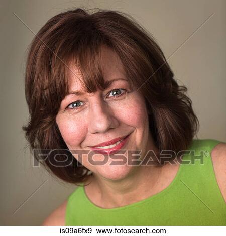 Stock Photo - Studio portrait of mature woman smiling. Fotosearch