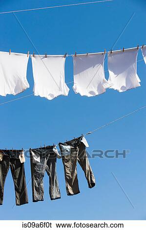 T shirts and trousers on clothes line View Large Photo Image Stock Photograph - T shirts and trousers on clothes line. Fotosearch