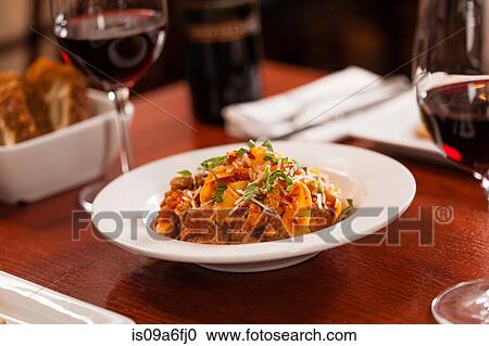 Table set with dish and red wine View Large Photo Image Stock Image - Table set with dish and red wine. Fotosearch