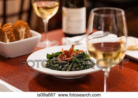 Stock Photo - Table set with dish and white wine. Fotosearch
