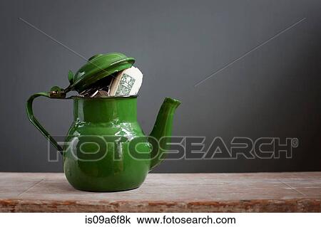 Teapot with dollar notes inside View Large Photo Image Stock Image - Teapot with dollar notes inside. Fotosearch
