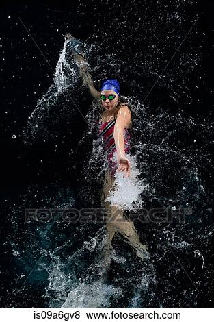 Stock Photo - Teenage girl doing backstroke in swimming pool. Fotosearch