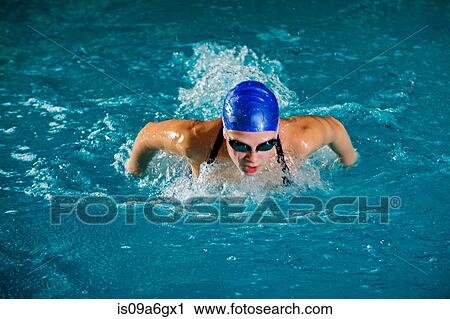 Teenage girl in swimming cap and goggles swimming in pool View Large Photo Image Stock Image - Teenage girl in swimming cap and goggles swimming in pool. Fotosearch