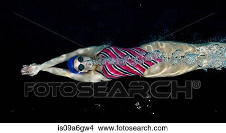 Teenage girl swimming underwater blowing bubbles View Large Photo Image Picture - Teenage girl swimming underwater blowing bubbles. Fotosearch