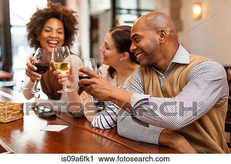 Stock Image - Three people toasting. Fotosearch