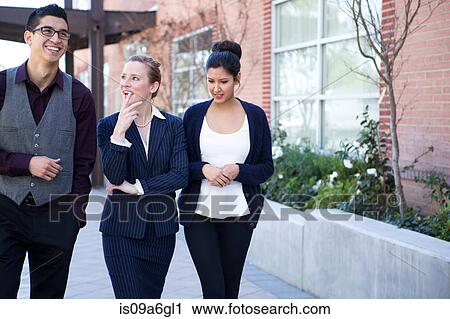Three young businesspeople outside office exterior View Large Photo Image Stock Image - Three young businesspeople outside office exterior. Fotosearch
