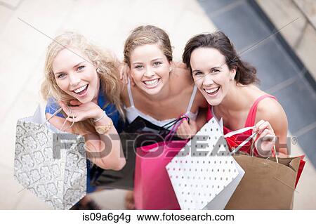 Three young women with their shopping bags View Large Photo Image Stock Image - Three young women with their shopping bags. Fotosearch