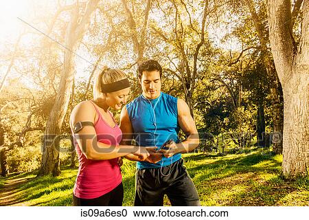 Two people exercising in forest having a rest View Large Photo Image Stock Image - Two people exercising in forest having a rest. Fotosearch