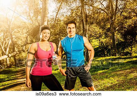 Stock Image - Two people having a rest from exercising. Fotosearch