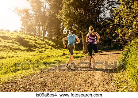 Two people jogging on forest path View Large Photo Image Picture - Two people jogging on forest path. Fotosearch