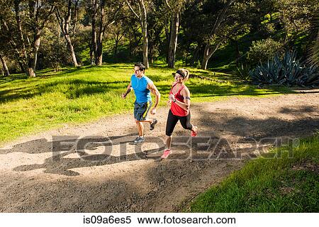 Two people jogging on forest path View Large Photo Image Stock Photography - Two people jogging on forest path. Fotosearch