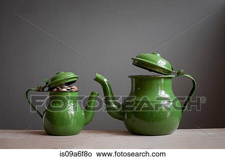 Two teapots with money inside View Large Photo Image Picture - Two teapots with money inside. Fotosearch
