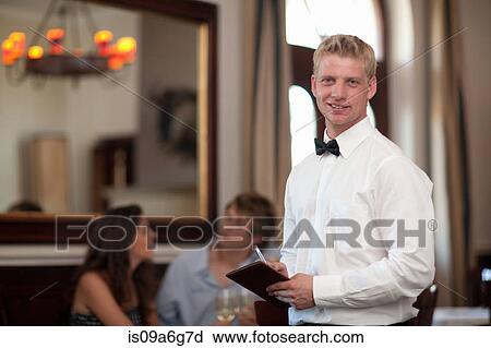 Stock Image - Waiter in restaurant. Fotosearch