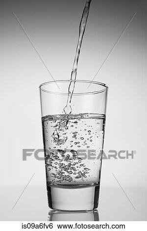Water being poured into drinking glass View Large Photo Image Stock Photograph - Water being poured into drinking glass. Fotosearch