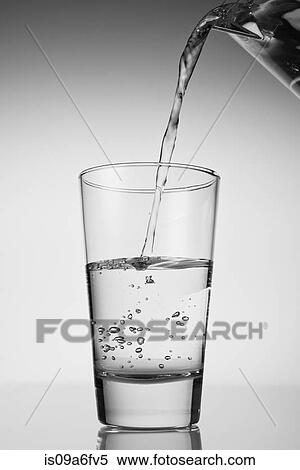 Water being poured into drinking glass View Large Photo Image Stock Photography - Water being poured into drinking glass. Fotosearch
