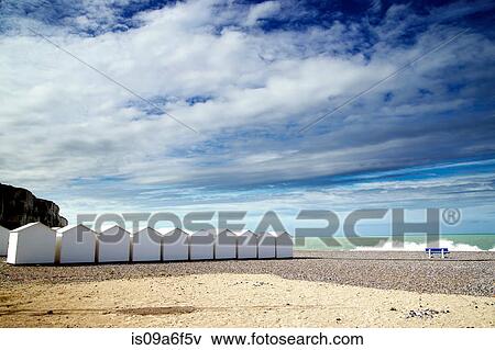 White beach huts in a row on shingle beach View Large Photo Image Stock Photo - White beach huts in a row on shingle beach. Fotosearch
