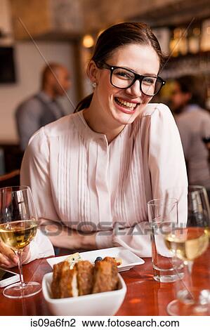 Stock Image - Woman at restaurant. Fotosearch