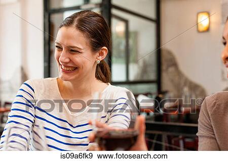 Stock Photo - Woman enjoying herself at wine bar. Fotosearch