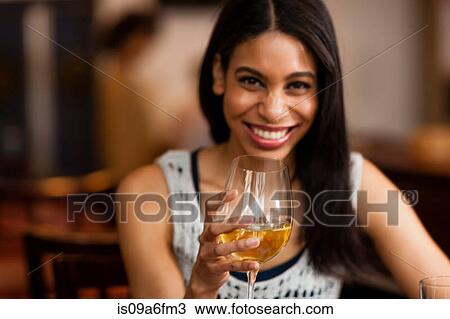 Woman having a drink View Large Photo Image Stock Image - Woman having a drink. Fotosearch