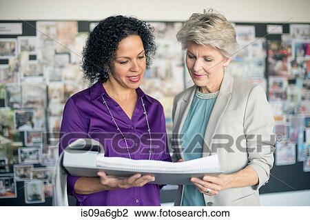 Stock Image - Women holding portfolio. Fotosearch