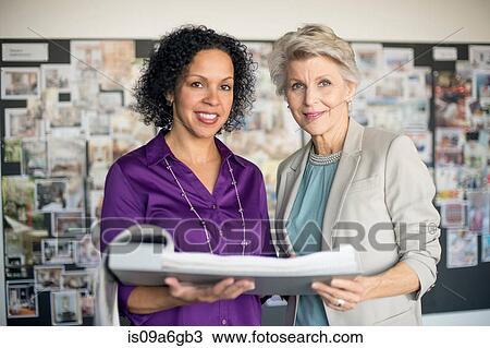 Stock Image - Women holding portfolio. Fotosearch