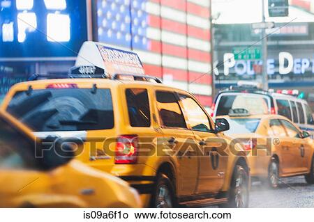 Picture - Yellow cabs and american flag, New York City, USA. Fotosearch