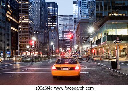 Stock Photograph - Yellow taxi cab at dusk, New York City, USA. Fotosearch