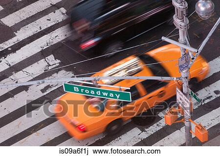 Stock Image - Yellow taxi cab on Broadway, New York City, USA. Fotosearch