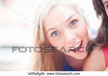 Stock Image - Young blonde looking at the camera. Fotosearch