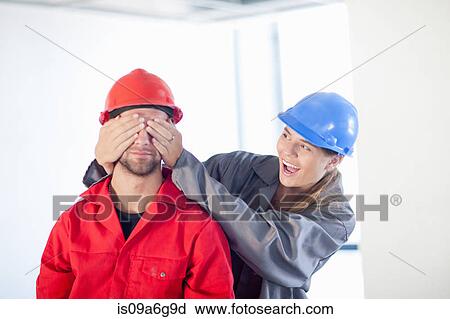 Young couple fooling around on construction site View Large Photo Image Stock Image - Young couple fooling around on construction site. Fotosearch