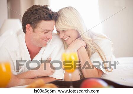 Young couple having breakfast in hotel room View Large Photo Image Picture - Young couple having breakfast in hotel room. Fotosearch