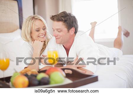 Young couple having breakfast in hotel room View Large Photo Image Picture - Young couple having breakfast in hotel room. Fotosearch