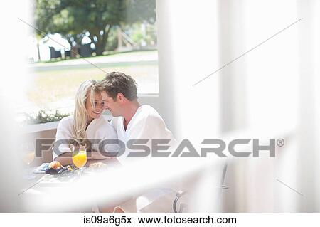 Young couple having breakfast on patio View Large Photo Image Stock Photo - Young couple having breakfast on patio. Fotosearch