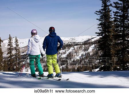 Young couple holding hands at top of ski run View Large Photo Image Stock Photograph - Young couple holding hands at top of ski run. Fotosearch