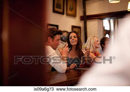 Young couple in bar View Large Photo Image Stock Image - Young couple in bar. Fotosearch