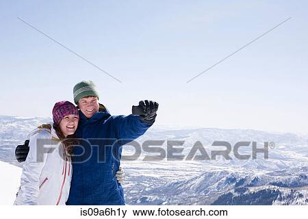 Young couple photographing selves, Brighton ski resort, Utah, USA View Large Photo Image Stock Photo - Young couple photographing selves, Brighton ski resort, Utah, USA. Fotosearch